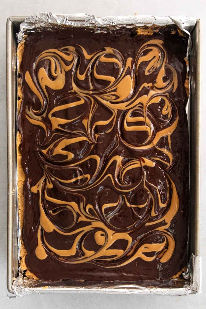 A rectangular pan of chocolate and peanut butter dessert bar batter.